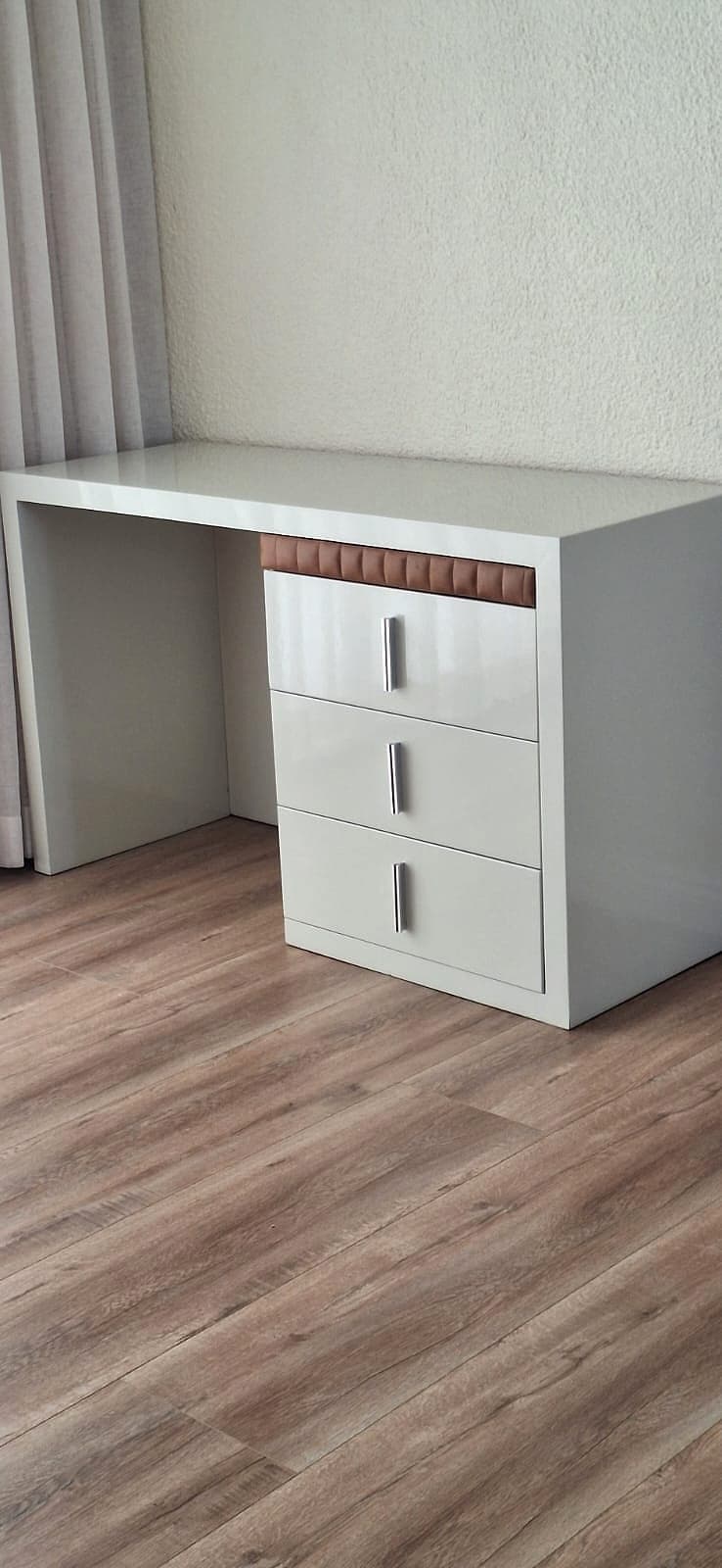 A white lacquer desk with leather trim in the Lavish Haus office collection